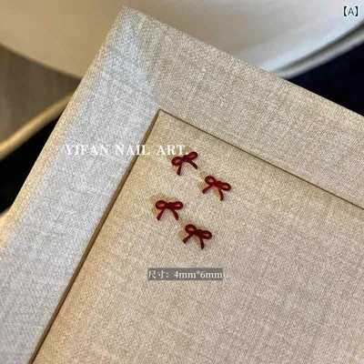 ネットの 赤い 蝶結びの ワインの フランスの ネイルアートの リボンの アクセサリーの ミニの 小さい 飾りの 蝶 ネクタイは 爪の 樹脂の 部品を 着ます。
